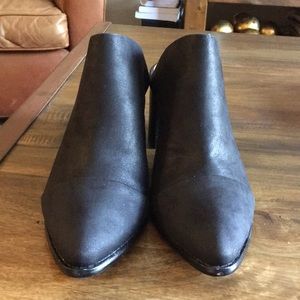 Report black heeled mule slides.